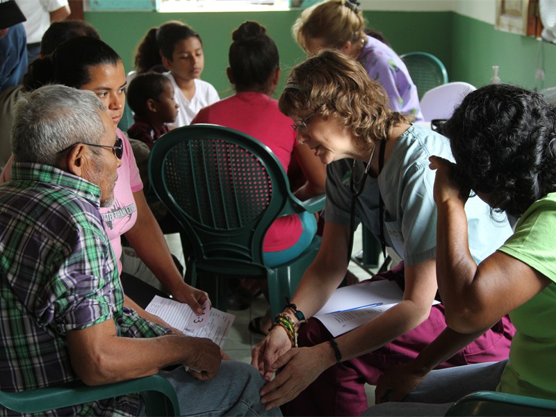 Doctor Kathy Praying with same older gentleman