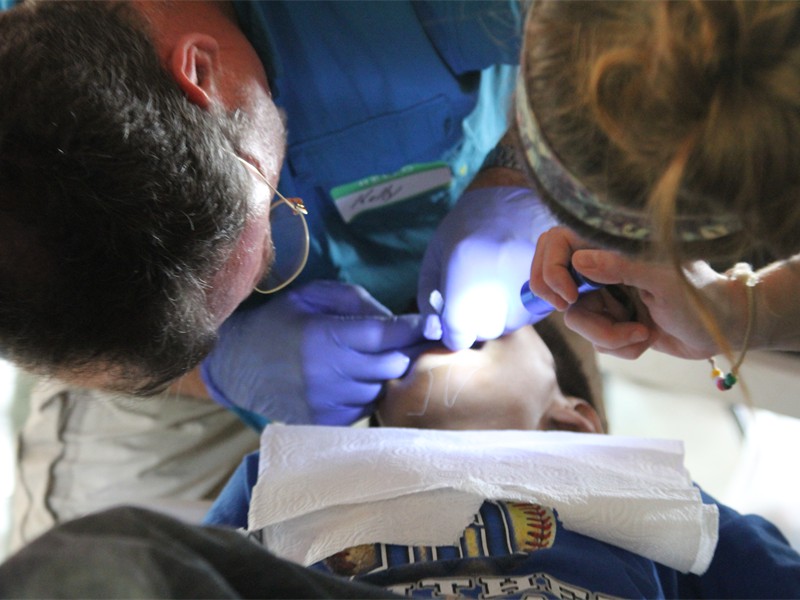 Team member pulling a tooth.  Not a dentist