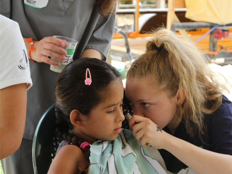 Child's Ear is flushed by one of the teens. 